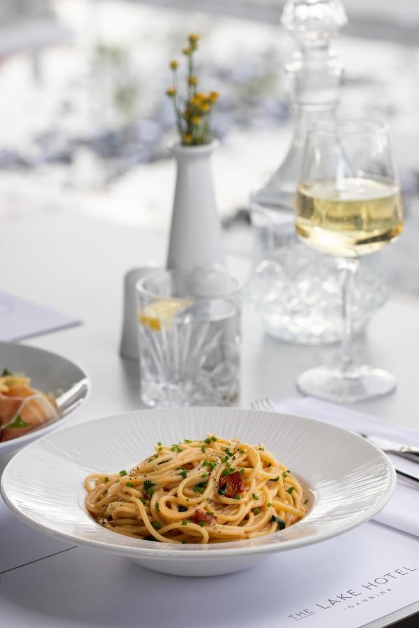 The Lake Hotel Ioánina Exterior foto A glass of white wine with a meal